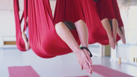 people relax after workout and lie in fly yoga hammocks