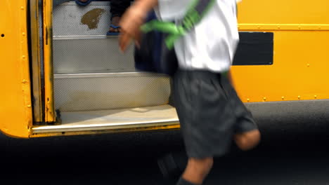 cute schoolchildren getting off the school bus