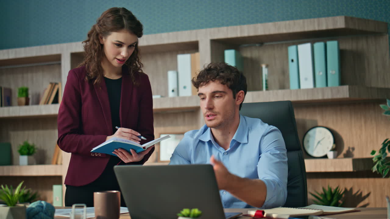 Business partners discussing strategy in office. Businessman looking laptop