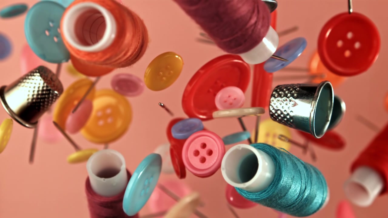 Colorful Sewing Supplies and Notions Falling in Slow Motion