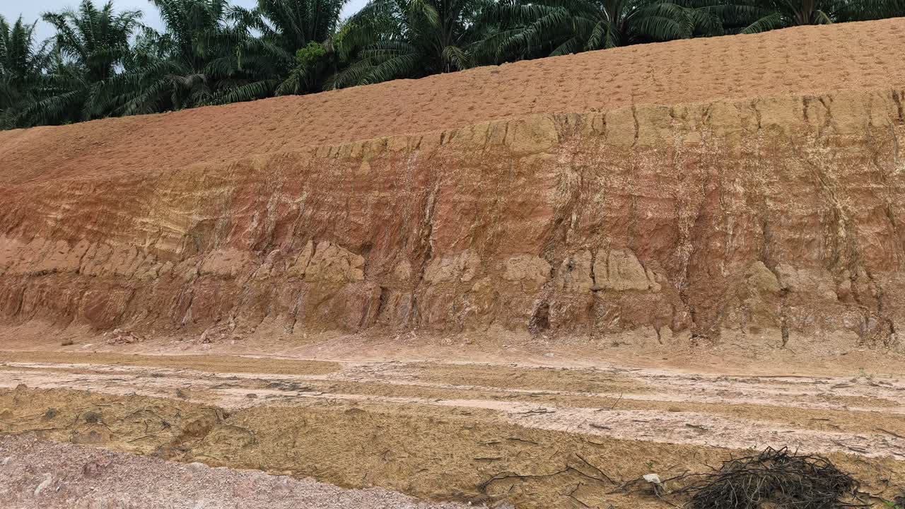 A cut hill and slope are exposed for infrastructure construction. The barren surface lacks protection, increasing the risk of erosion, danger, and potential landslides