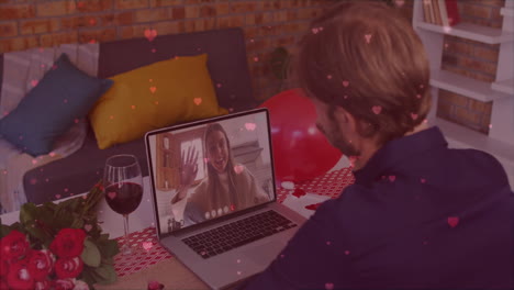 animation of hearts falling over caucasian man having video call with caucasian woman