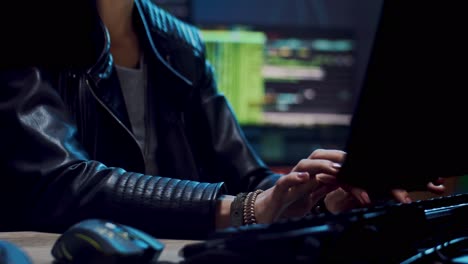 Close-Up-Of-The-Young-Beautiful-Woman-Software-Developer-In-Glasses-Working-Over-The-Computer-Programs-At-The-Dark-Room