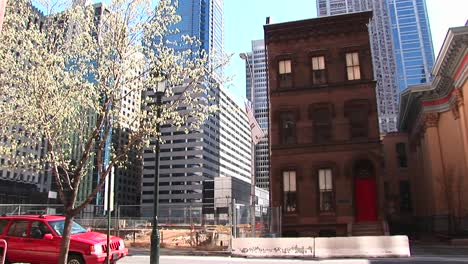 an older neighborhood of brownstone homes is clearly losing ground to the need for more and more skyscrapers