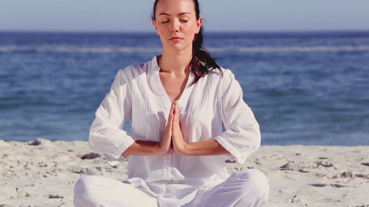 Woman meditating in sukhasana pose