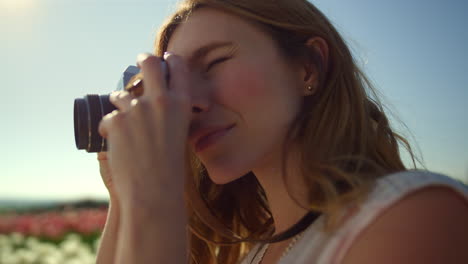 Closeup-young-woman-shooting-photos.-Serious-woman-taking-pictures-outdoors.