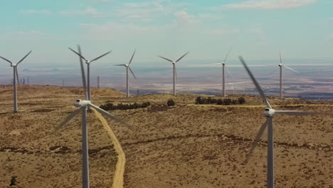 A-tranquil-shot-of-the-windmills-working-at-the-top-of-the-hill