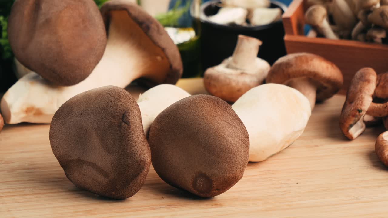 Assortment of Fresh Mushrooms on a Wooden Board