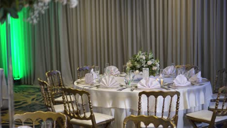 round table decorated for a wedding, with a small centerpiece with gypsophila paniculate flowers