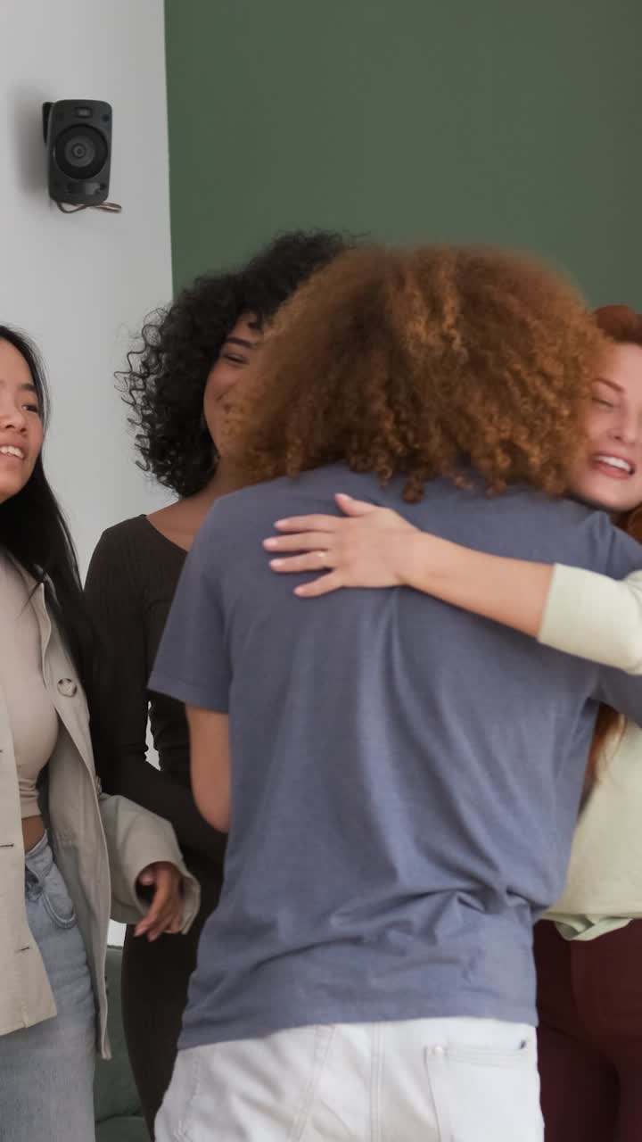Multiethnic friends embracing each other at home