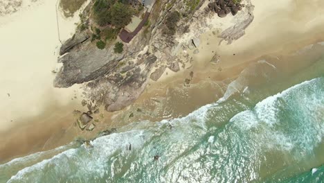 Rocky-Headland-,crystal-clear-water,-small-waves,-from-the-vertical-,-Rotating-for-effect