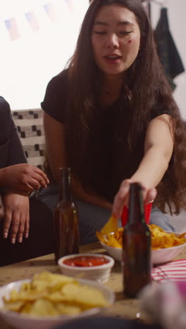 vertical video of friends drinking beer and eating snacks at party celebrating american independence day 4th july