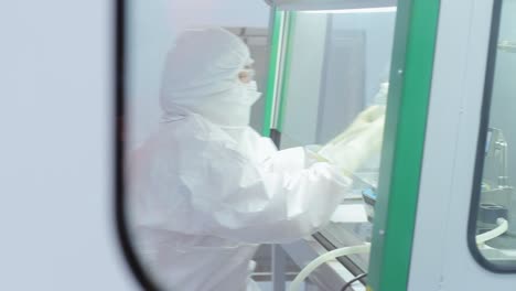 scientist in protective suit working at laboratory. pharmacological technologies