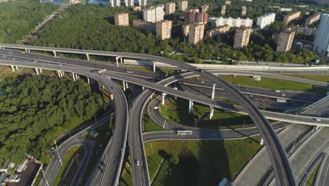 multi-level road interchange and cars traffic. drone is flying around. aerial view.