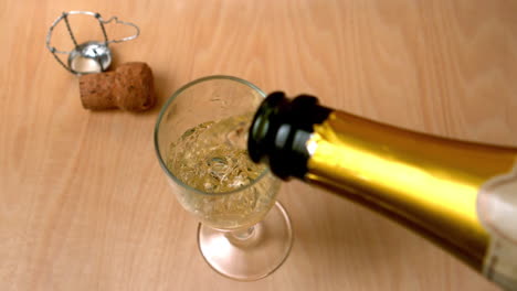 High-angle-view-of-champagne-being-poured-into-flute