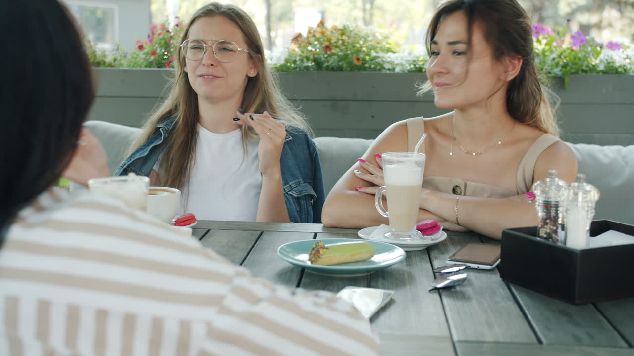 Friends enjoying coffee in an outdoor cafe