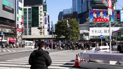 pedestrians crossing a busy urban intersection