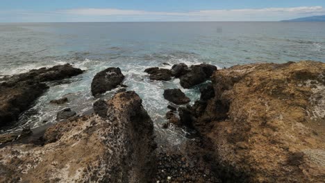 static shot of the sea waves hitting the rocks