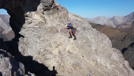 Hiker-carefully-walking-on-steep-rock-Kananaskis-Alberta-Canada