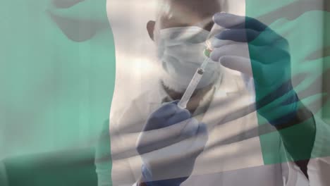Animation-Der-Flagge-Nigerias,-Die-über-Einem-Arzt-Weht,-Der-Eine-Gesichtsmaske-Trägt-Und-Einen-Impfstoff-In-Der-Hand-Hält