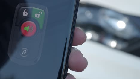 unlock and lock car using smartphone app. man hand unlocking car by use mobile application on a smart phone. key remote control and car protection through the internet. car technology with smartphone.