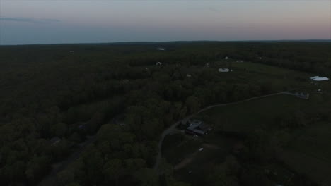 aerial pan of woods during sunset