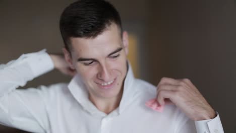 groom getting ready in the morning. handsome groom getting dressed and preparing for the wedding