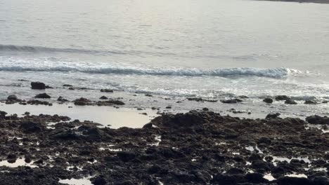 Tenerife-rocky-volcanic-island-shoreline,-sea-ocean-waves-calm-relaxing