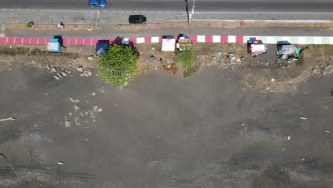 aerial drone view overflying side street vendor shops in the highway at port caldera, puntarenas, costa rica