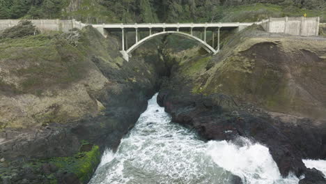 aerial static view of bridge and blowhole at captain cook point, cape cove, oregon coast