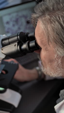 scientist using microscope