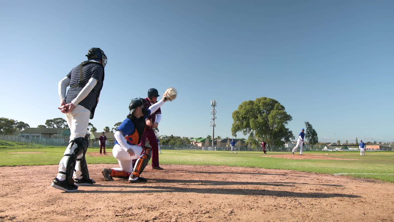 Playing baseball, catcher and batter waiting for pitch on sunny field
