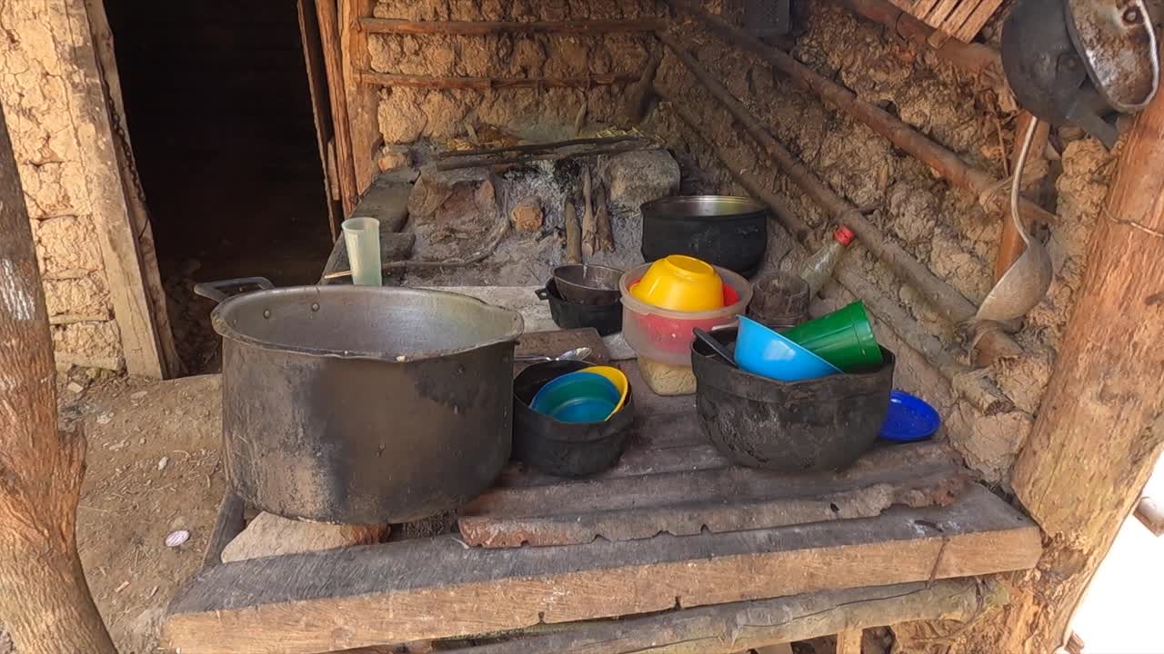 Simple outdoor kitchen in Caripito with wood cooking and pots