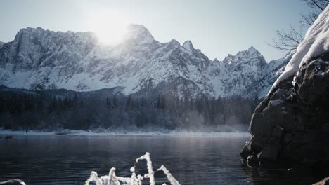 Spectacular-Fusine-Lake-at-sunset,-framed-by-majestic-mountains