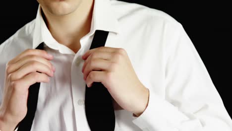 Androgynous-man-removing-bow-tie