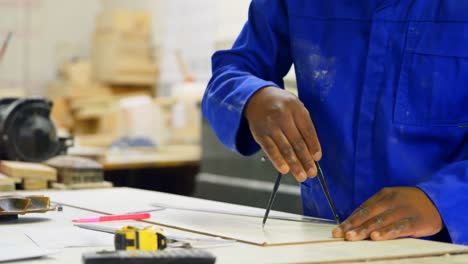Worker working at table in workshop 4k