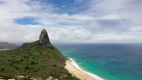 Drone-view-of-Morro-do-Pico-with-beach-and-sea-in-the-background-in-Fernando-de-Noronha,-Brazil