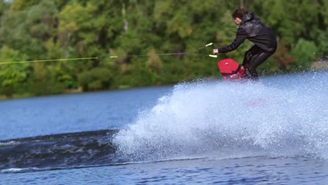 Man-wakeboarder-making-tricks-on-water.-Man-falling-down-in-water