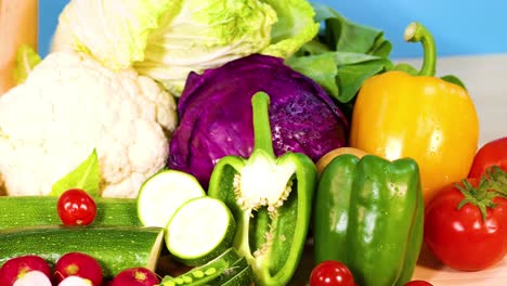 assorted vegetables displayed against a blue background