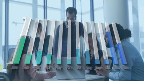 team collaborating around modern conference table, displaying finance bar chart overlay on laptop