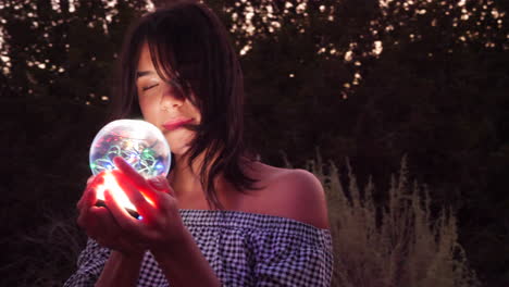 A gorgeous woman enchantress wandering in a fantasy landscape with a magical spiritual orb glowing in illuminated light