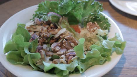 using fork eat fresh salad in white bowl for breakfast