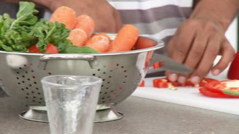 Close-up-of-people-cutting-vegetables-in-the-kitchen