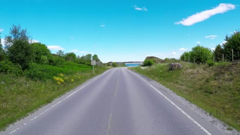 Driving-a-Car-on-a-Road-in-Norway-Atlantic-Ocean-Road-or-the-Atlantic-Road-(Atlanterhavsveien)-been-awarded-the-title-as-(Norwegian-Construction-of-the-Century).