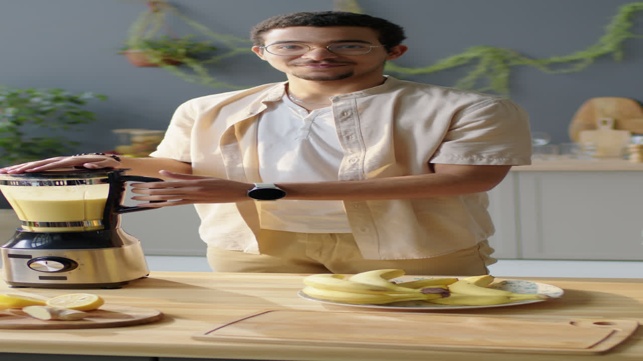 Portrait of Cheerful Man Making Smoothie in Blender
