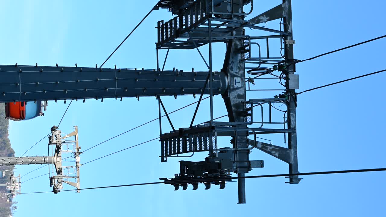 Gondola lift moving above the mountains in Piatra Neamt, Romania. Vertical