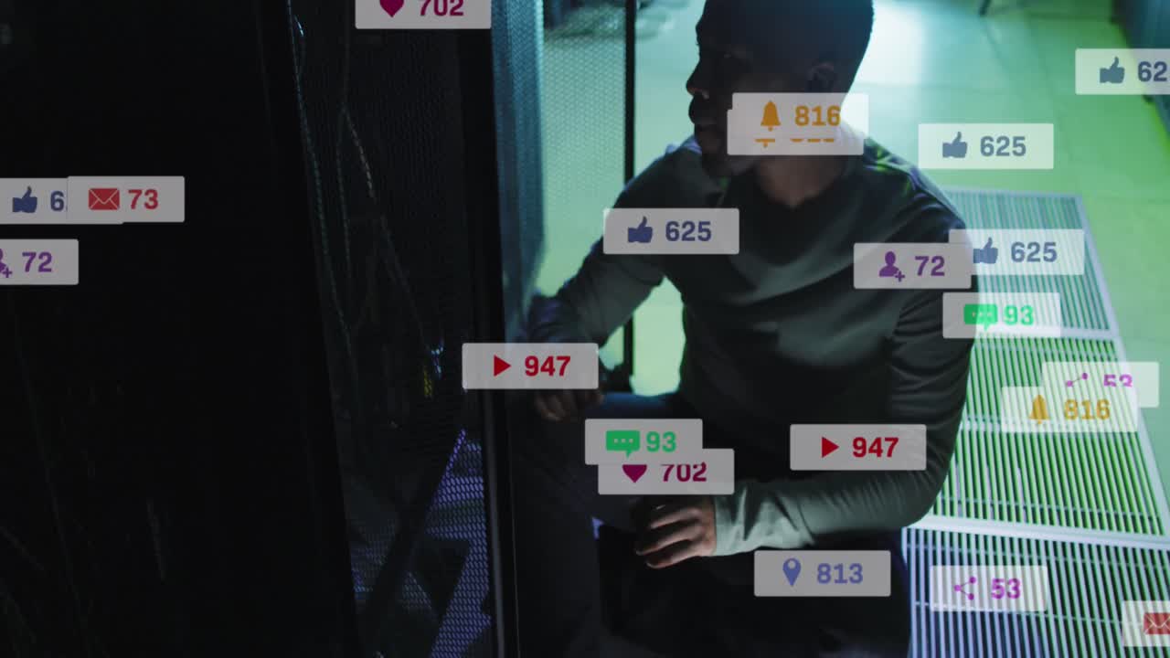 Animation of icons and numbers over african american male it technician by computer servers