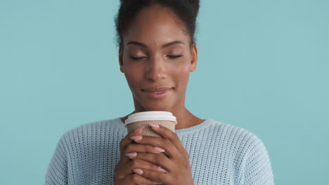 happy woman smelling the great aroma from her hot coffee