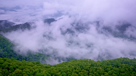 aerial footage of soft fog rolling over the ancient mountain ridges