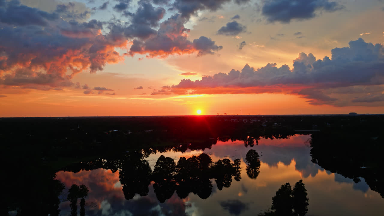 A Brilliant and Beautiful Orange Sunset Over The River In Tampa, Florida - Slow and Steady Aerial Shot